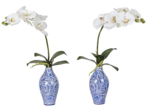 A pair of Orchid Phalaenopsis in white faux arrangements is placed in ceramic vases, each boasting intricate floral patterns. The set includes two vases, each 17 inches tall, containing orchids in full bloom with several flowers per stem.