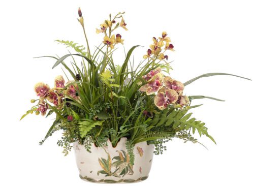 A decorative ceramic pot filled with a variety of orchids and lush green foliage. The orchids are yellow and purple with intricate patterns, surrounded by tall grass-like leaves and ferns, creating an elegant floral arrangement.