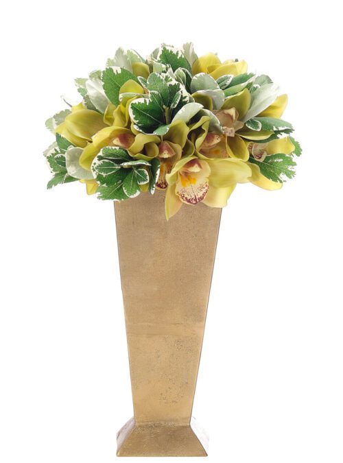 Tall gold vase with a bouquet of yellow and green flowers, featuring lush leaves and delicate orchid blossoms, arranged with variegated foliage.